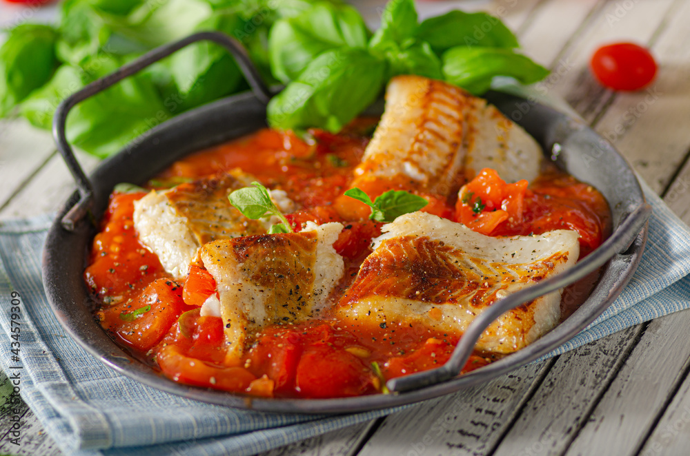 Delicious grilled fish with tomato sauce