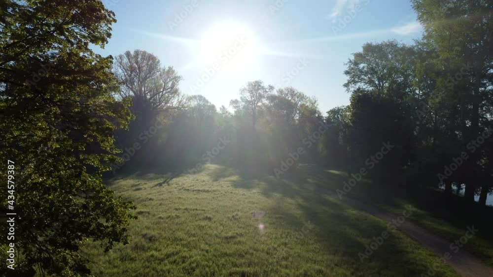 Aerial drone view flight over dirt path in park in early morning Aerial drone view flight over dirt path in park in early morning