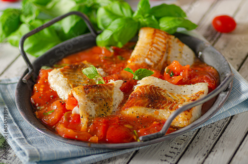 Delicious grilled fish with tomato sauce