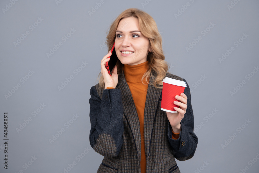 Girl talk on phone drinking tea. Telephone conversation. Enjoying her conversation and hot drink Girl talk on phone drinking tea. Telephone conversation. Enjoying her conversation and hot drink