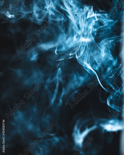 Blue smoke on black background isolated © roman