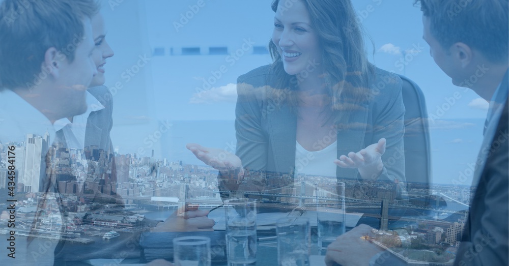 Composition of businesswoman in meeting with businessmen over cityscape