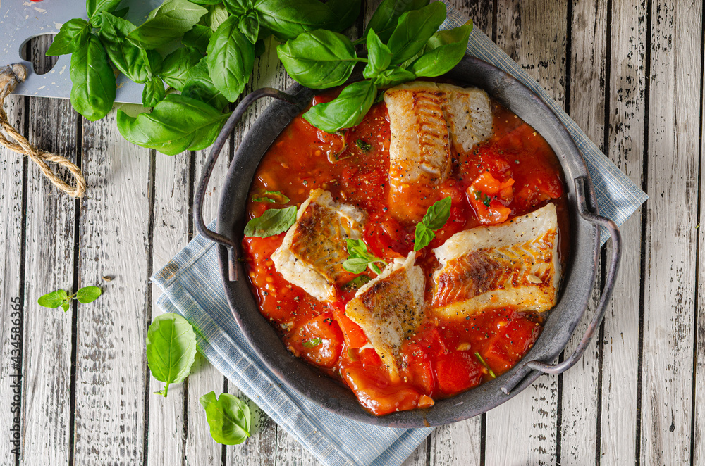 Delicious grilled fish with tomato sauce