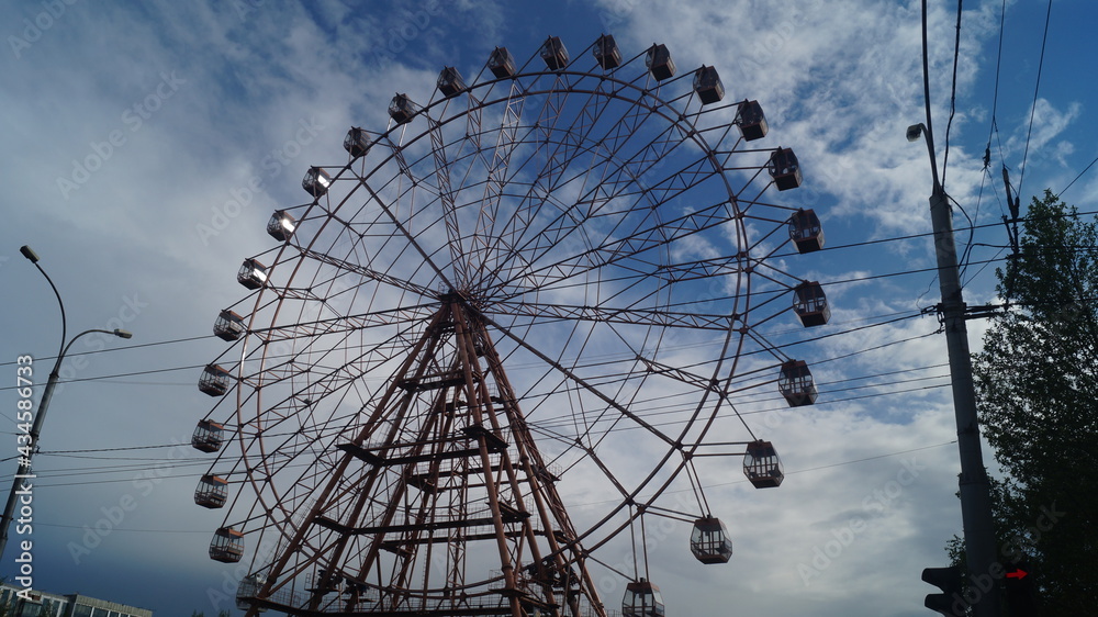 ferris wheel closed booths against the blue sky ferris wheel closed booths against the blue sky