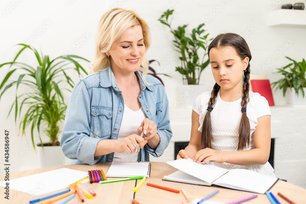 Mother and daughter spending time together at home drawing Mother and daughter spending time together at home drawing