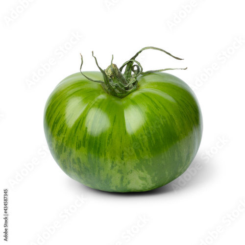 Single whole fresh green zebra tomato close up isolated on white background 