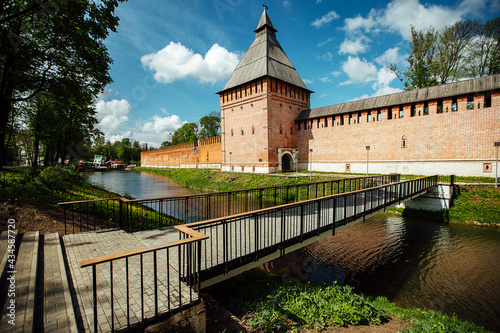 the bridge over the pond near the castle. an old stone fortress with high towers and brick walls. tourist attraction located in the center of the old town. summer landscape with a historical building