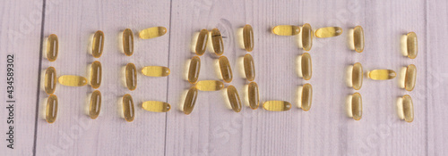 Flat lay with pills about health on white wooden background
