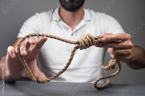 man holding a noose. suicide concept photo