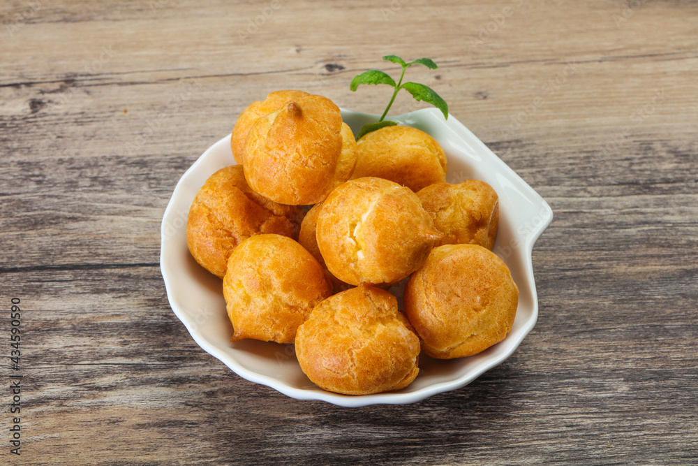 Sweet tasty profiteroles heap in the bowl Sweet tasty profiteroles heap in the bowl