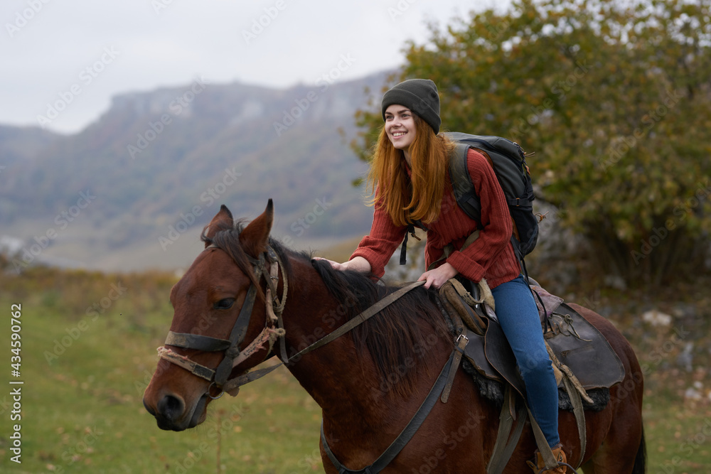 cheerful woman Tourist riding a horse nature mountains joy cheerful woman Tourist riding a horse nature mountains joy