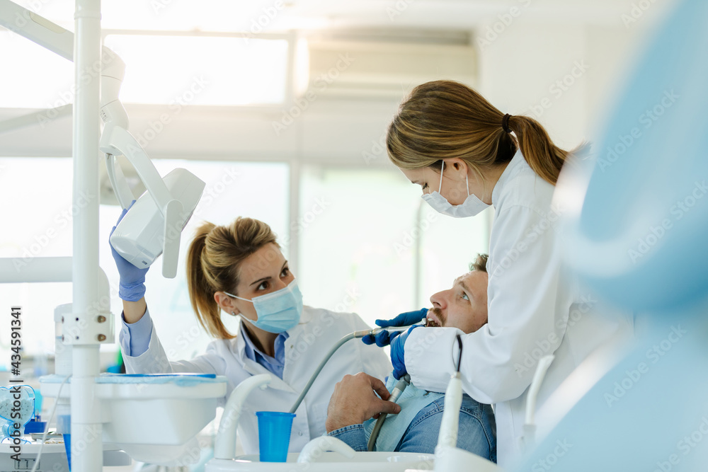 Man having teeth examined at dentists.