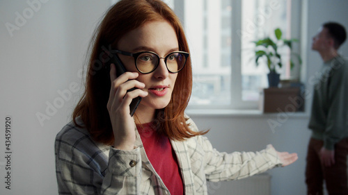 Girl with glasses complains about her boyfriend on the phone