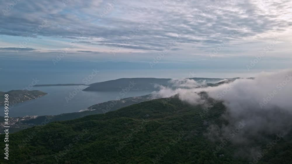 Aerial view of the entrance to the Bay of Kotor, Herceg Novi, Montenegro, with the mountains and fog at sunset. Aerial view of the entrance to the Bay of Kotor, Herceg Novi, Montenegro, with the mountains and fog at sunset.
