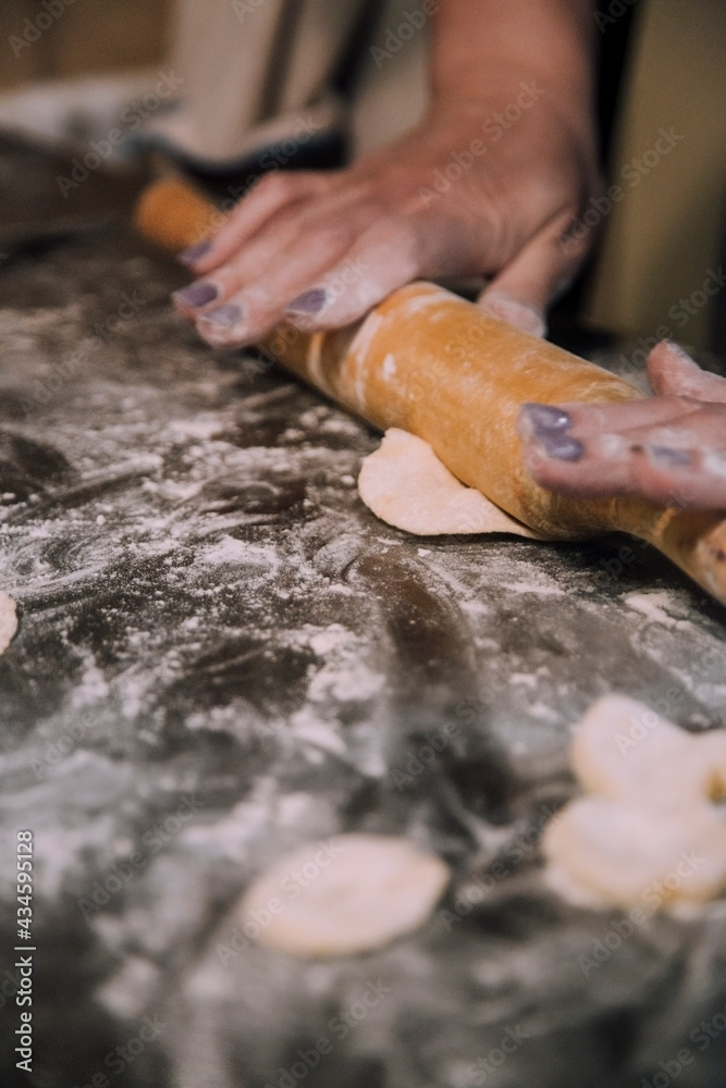 girl working with dough on the table 