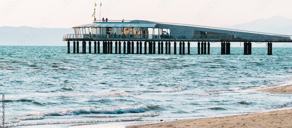 Modern pier on a sunny day, touristic conceptual image, italian pier in lido di camaiore, italy