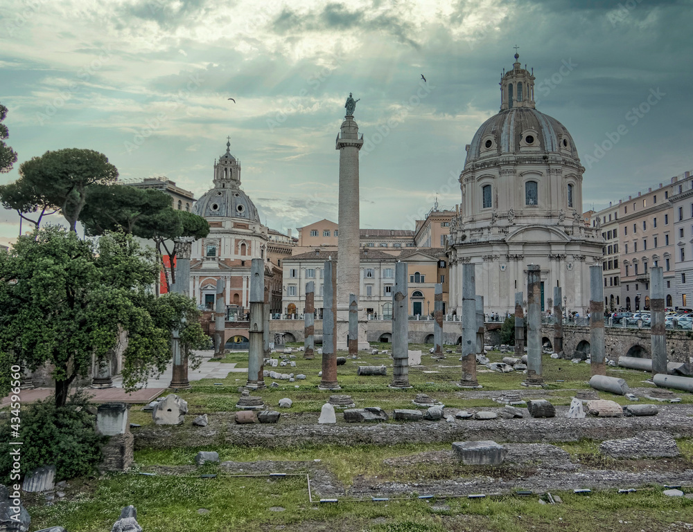 Rome Italy, picturesque view of the Trajan forum undre dramatic cloudy sky and sun rays