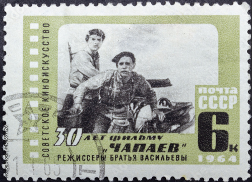 Postage stamp 'Shot from the film 'Chapaev' directors - brothers Vasiliev' printed in USSR. Series: '30th anniversary of the movie 'Chapaev'' by artist E. Beketov, 1964 photo