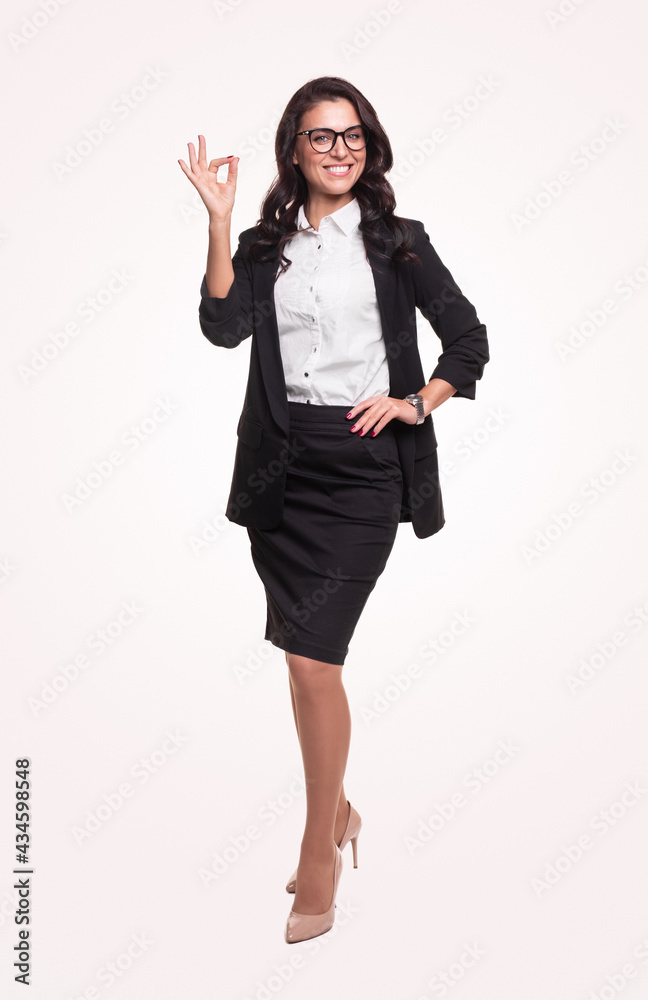 Delighted businesswoman showing OK gesture in studio Delighted businesswoman showing OK gesture in studio