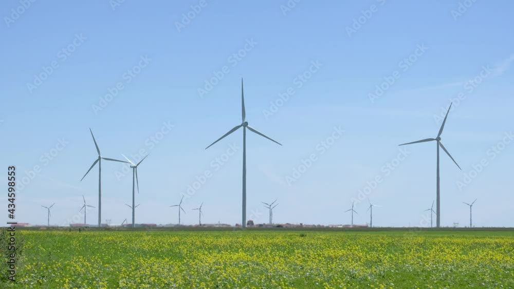 Field of windmills in spring. Renewable energies Field of windmills in spring. Renewable energies