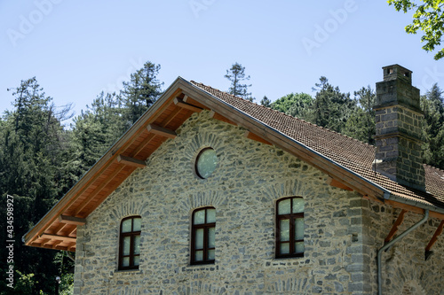 Stone building with a gable roof. Historical stone house.