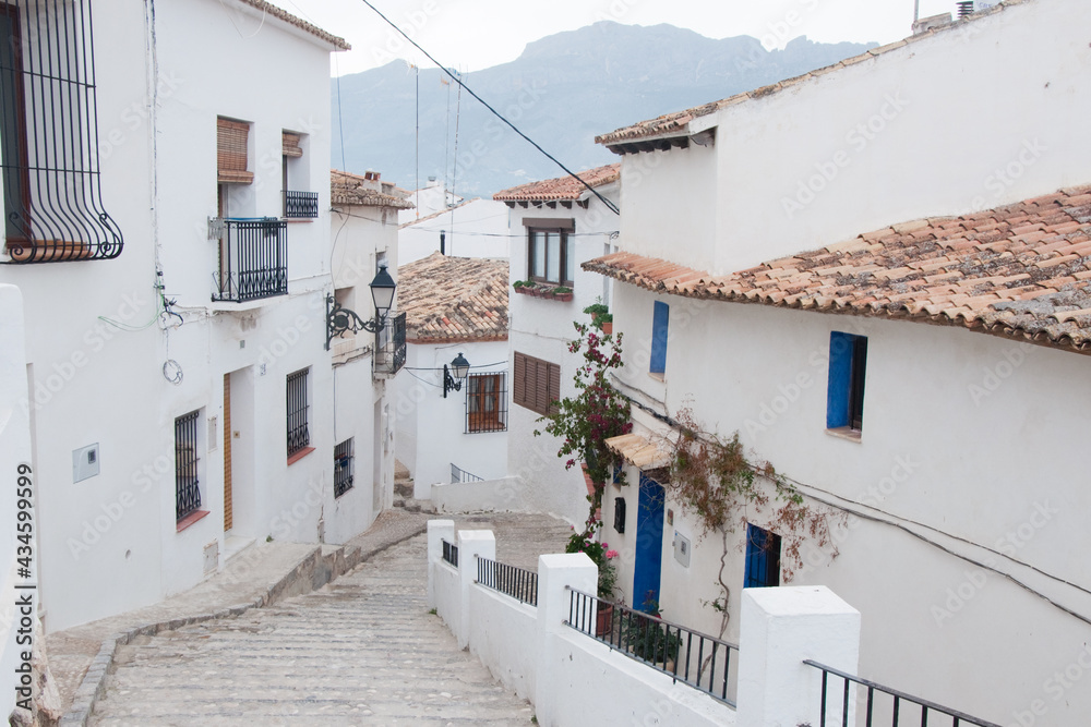 Beautiful street at Altea with white houses, blue doors and windows and no people.Spain