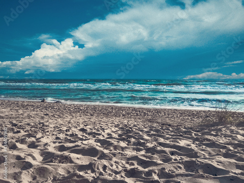 Ocean coast. White sand and azure blue ocean with beautiful clouds.