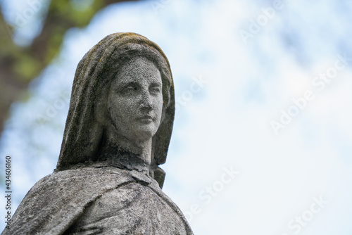 Antique statue of Virgin Mary. Religion, faith, suffering and love concept. Copy space for design.