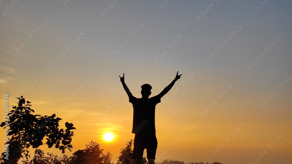 silhouette of a person in the sunset