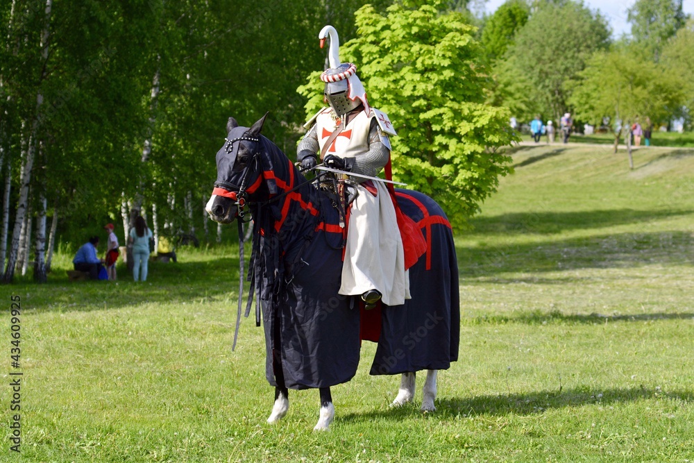 Knight in armor on a horse. Horse rider. Knight Templar. Knight Tournament. Belarus