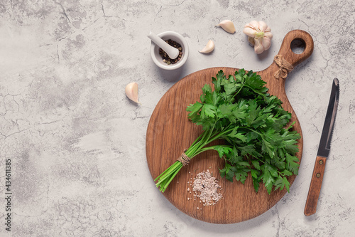 cutting board, parsley on a concrete table