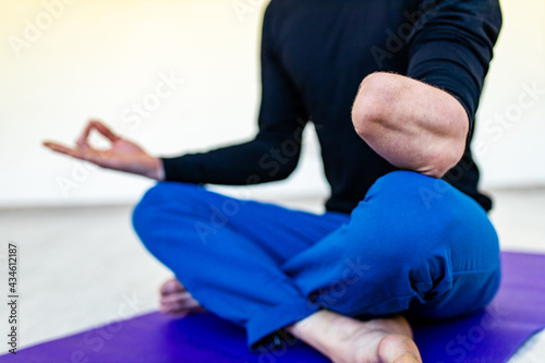 amputees handisport young man doing yoga exercises indoors at home