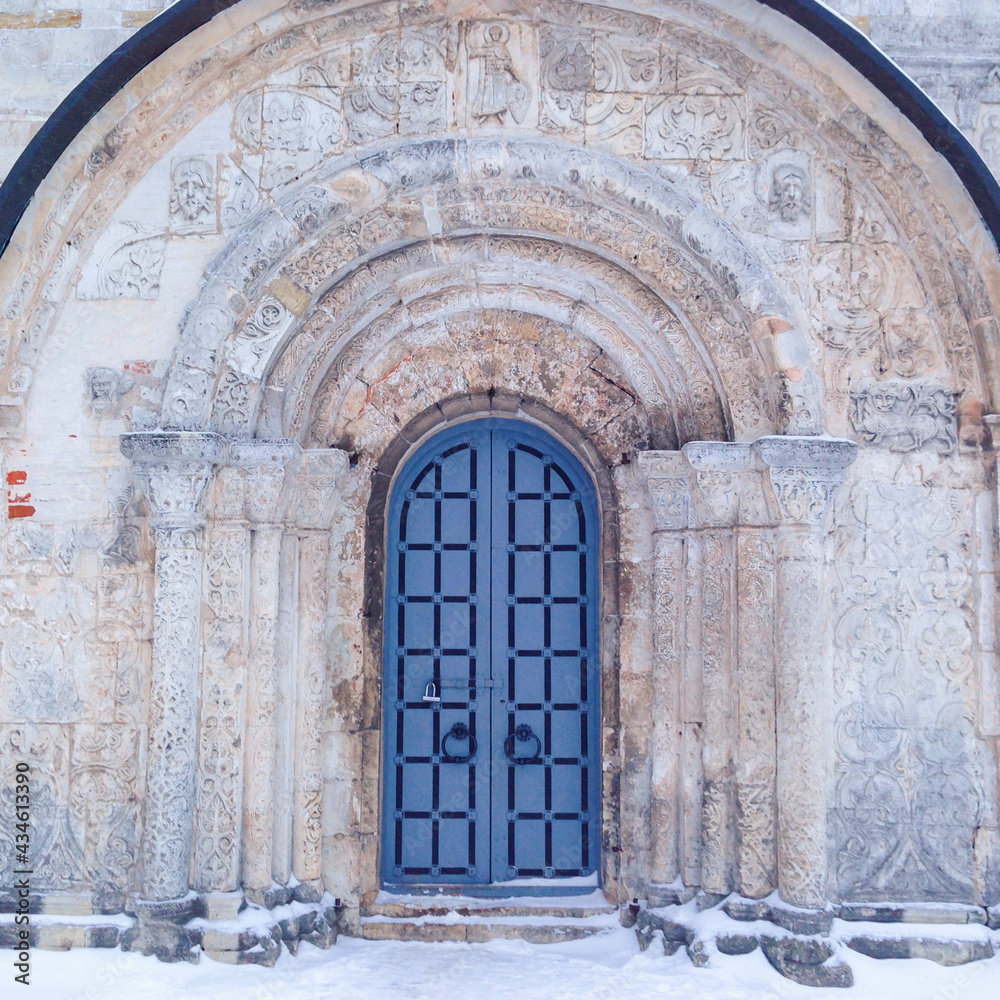 Old gate of monastery in winter