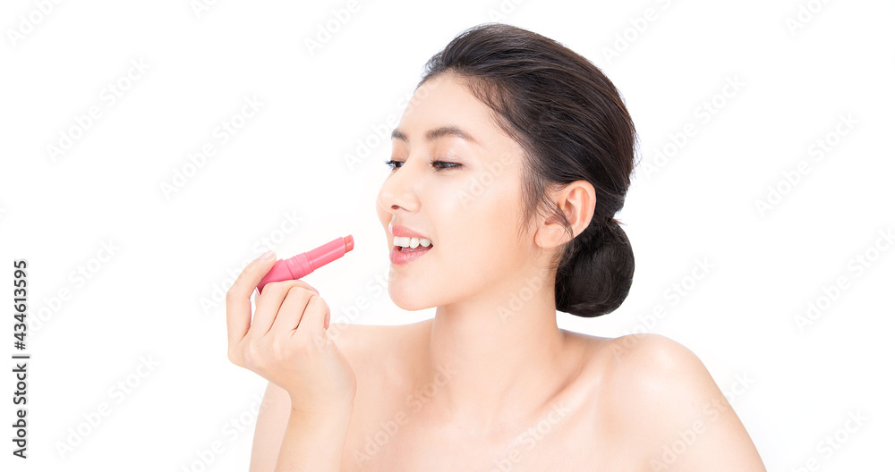 Portrait beauty asian woman fair perfect healthy glow skin.Girl hand holding apply pink lipstick. Posing a product. Gestures for advertisement. Asia model girl with pretty smile on face isolated. Portrait beauty asian woman fair perfect healthy glow skin.Girl hand holding apply pink lipstick. Posing a product. Gestures for advertisement. Asia model girl with pretty smile on face isolated.