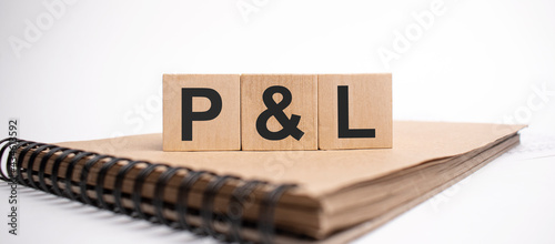 Text p and l on the wooden cubes and craft colored notepad on the white background photo