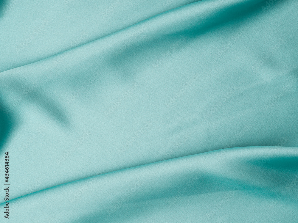 Green satin texture background with waves and crease Green satin texture background with waves and crease