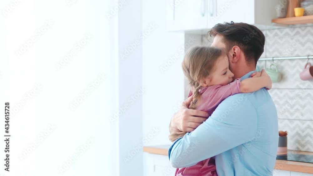 Hugging young father and little daughter. Happy family at home Hugging young father and little daughter. Happy family at home