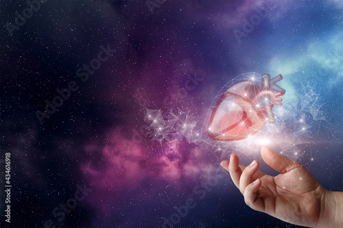 Hand shows the heart on the background of the cosmos in the network .