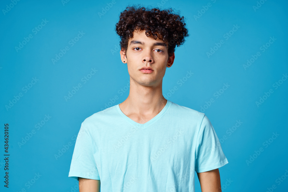 guy in blue t-shirt curly hair cropped view isolated background guy in blue t-shirt curly hair cropped view isolated background