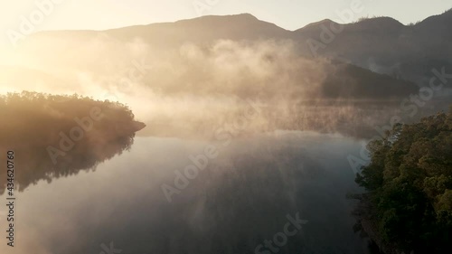 4K Drone footage of misty lake surrounded with mountains in Kotagiri, Nilgiris, Chennai Tamil Nadu, India 60FPS for slow motion photo