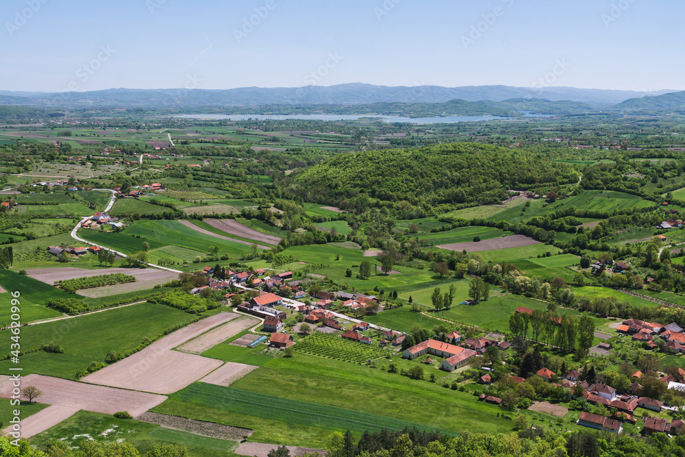 View over the villages and farm fields in the valley to the Gruža lake in Serbia View over the villages and farm fields in the valley to the Gruža lake in Serbia