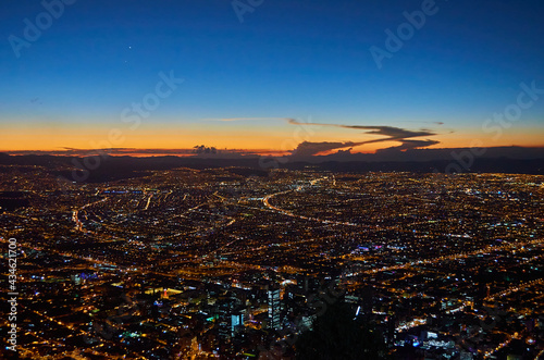 A view of the city of Bogota from the Monserrate hill at dusk, with a beautiful horizon with vibrant blue and orange colours. photo