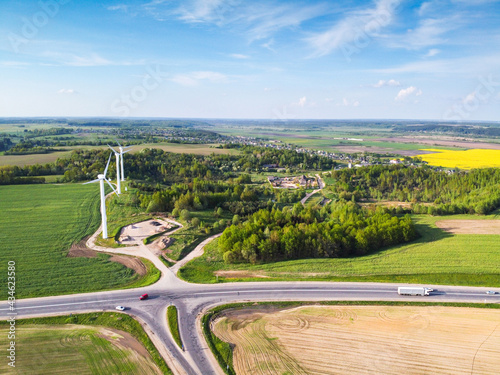 Wind turbines in green field, aerial view. Green energy
