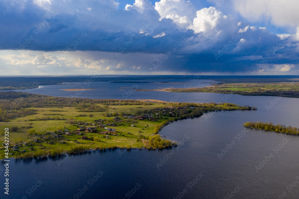 A forested cape on Lake Selyava, illuminated by the evening sun. A forested cape on Lake Selyava, illuminated by the evening sun.
