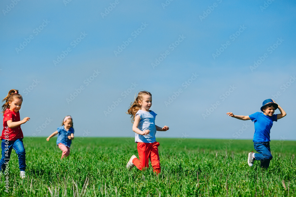 Running kids in green field during summer. Running kids in green field during summer.