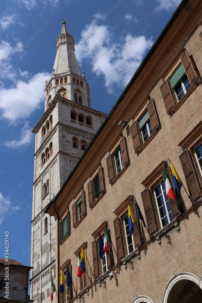 Modena, Italy, Ghirlandinna tower and municipal palace with flags, Unesco world heritage site