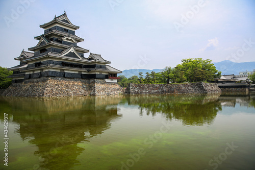 Matsumoto Castle, known as The Crow Castle surrounded by a green water moat, Matsumoto, Japan.