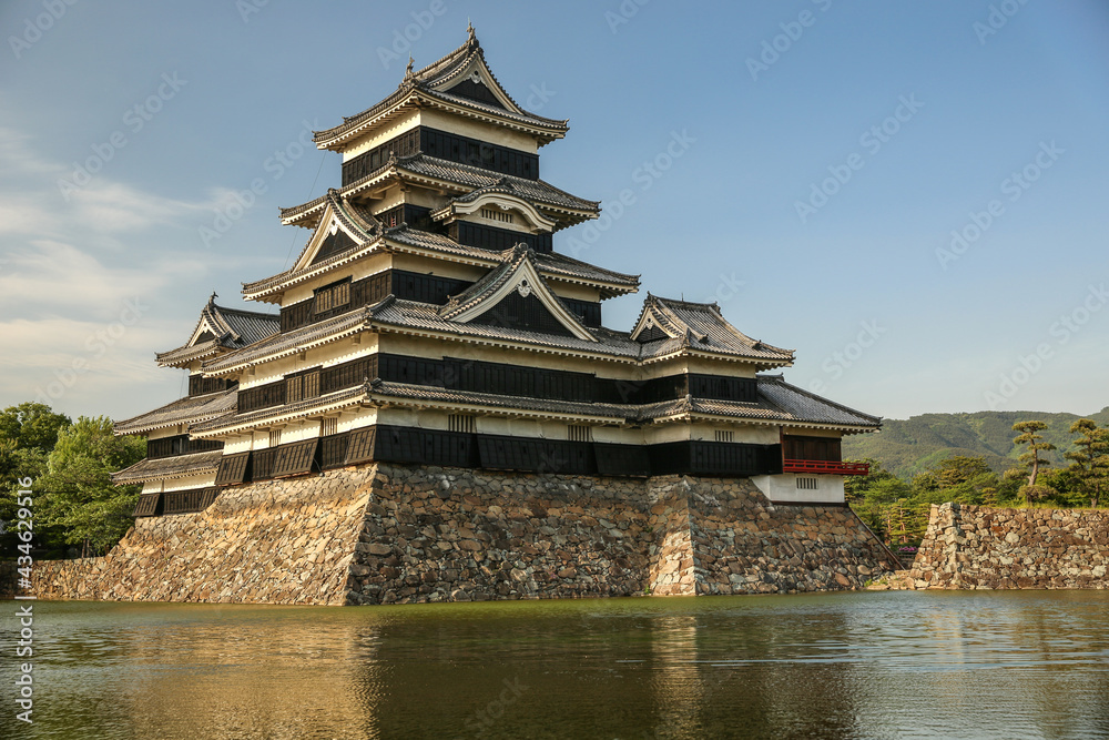 Matsumoto Castle, known as The Crow Castle on a summer day surrounded by a water moat, Matsumoto, Japan.