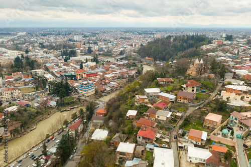 General aerial view of Kutaisi cityscape on banks of Rioni River in springtime, Imereti region, Georgia