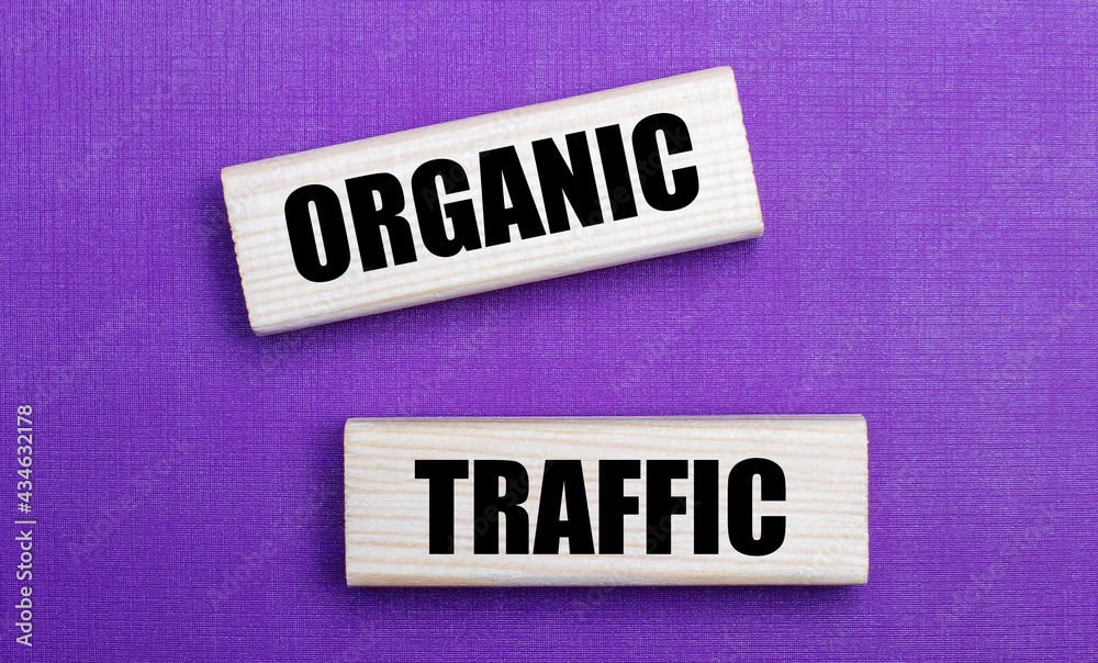 On a lilac bright background, light wooden blocks with the text ORGANIC TRAFFIC On a lilac bright background, light wooden blocks with the text ORGANIC TRAFFIC